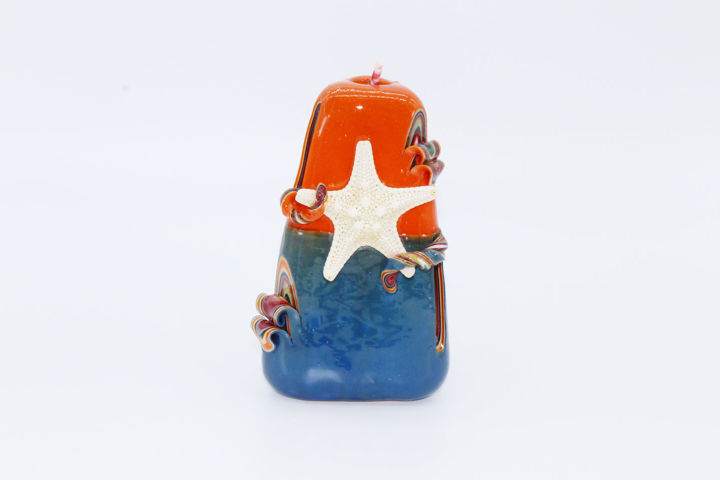 Blue and orange "sea" carved candle
