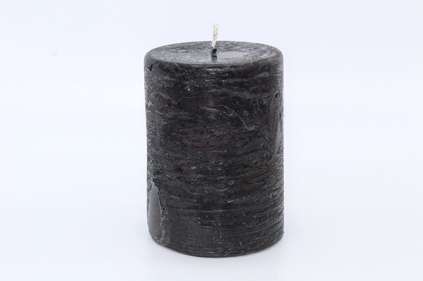 Black cylindrical raw effect candle