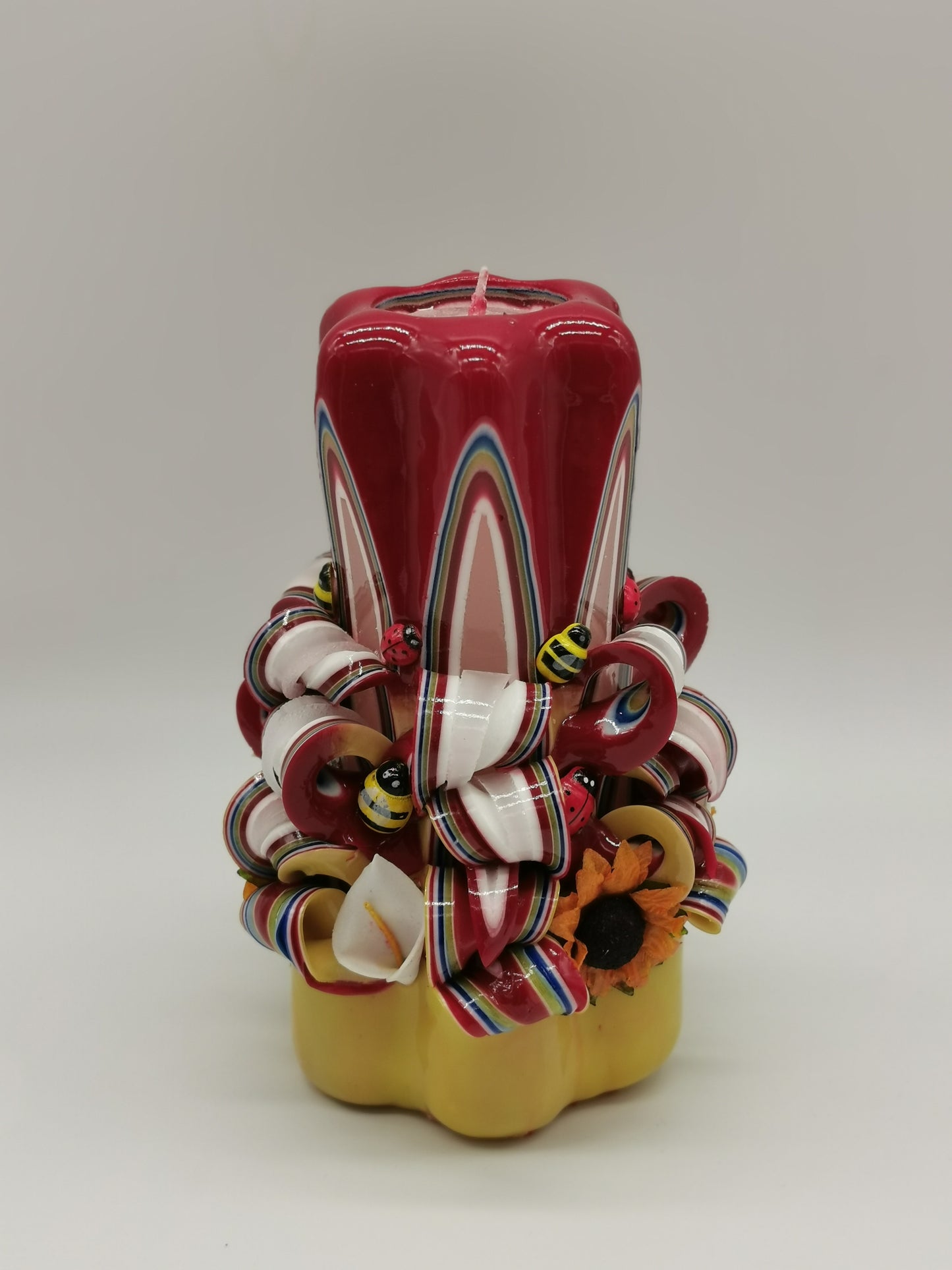 Yellow and red "spring" carved candle